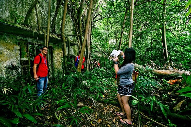 Heritage trail walkers at a wooded area in Kay Siang Road, where the remnants of two long-abandoned storage bunkers lie.