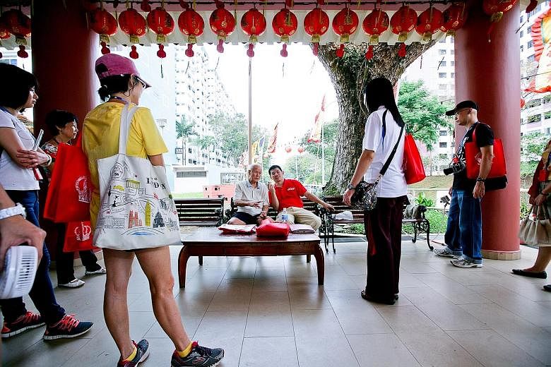 Participants learning more about Tiong Ghee Temple, the oldest Taoist temple in Queenstown. Now located in Stirling Road, it can trace its history back to the 1930s.