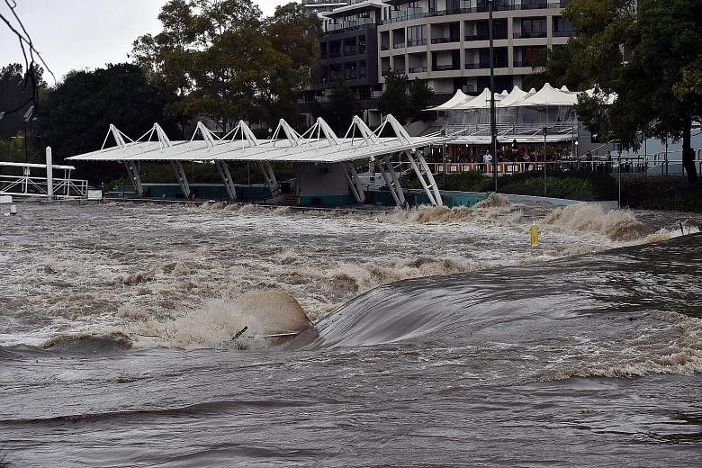 A Sydney ferry terminal submerged by floodwaters after the freak storm struck yesterday. High winds forced Sydney Airport to close two of its three runways.