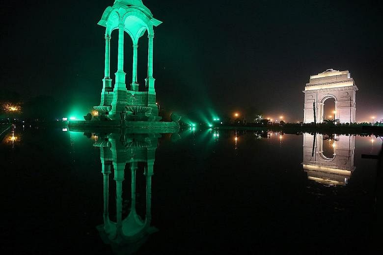 The Canopy (left) in New Delhi being lit up in green on Saturday, the eve of World Environment Day. The event is observed annually on June 5. It is the United Nations' most important day for encouraging worldwide awareness and action for environment 
