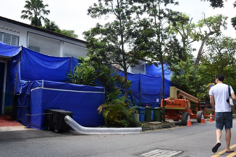 Three houses in Jalan Hitam Manis were enclosed in sheets for asbestos removal when The Straits Times visited Chip Bee Gardens last week. 