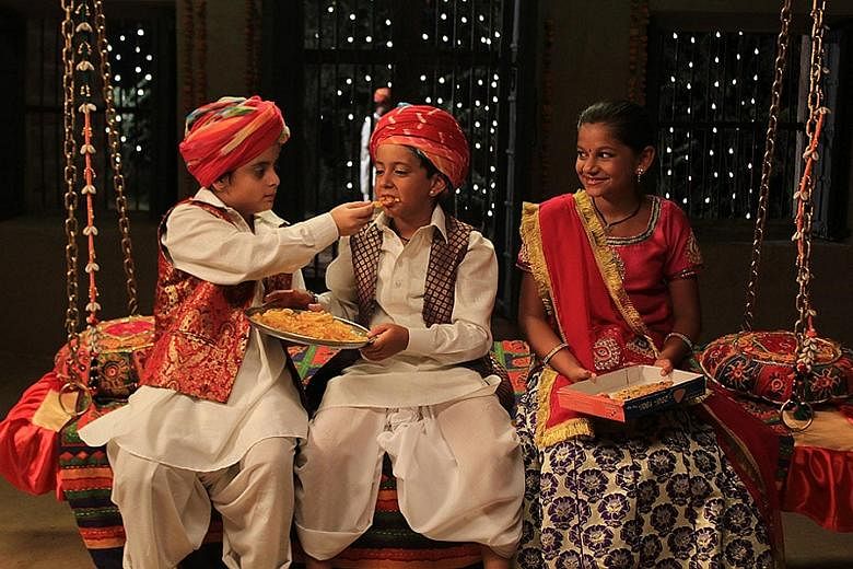 Krrish Chhabria (centre) and Hetal Gada (right) play orphan siblings who meet exotic characters on the road and learn not to judge books by their covers.