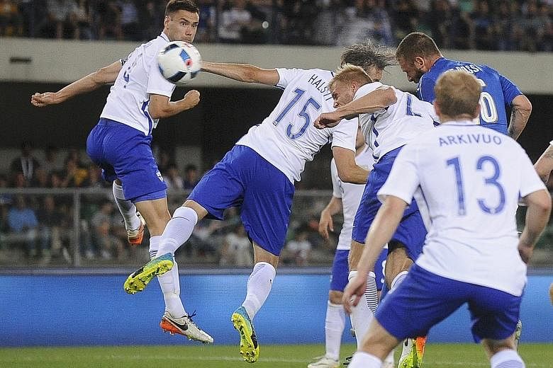 Daniele de Rossi (in blue) heading in Italy's second goal against Finland in a friendly match which ended 2-0. The Azzurri have also defeated Scotland in their preparation for the European Championship.