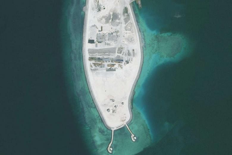 One of the two new lighthouses is being built on Mischief Reef (left), while the other is on Fiery Cross Reef. Lighthouses are part of Beijing's controversial expansion and building of civilian and military facilities in the South China Sea.