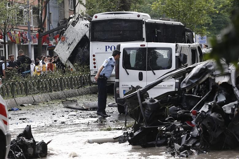 A police officer at the scene of the bomb attack on a police bus in Istanbul yesterday. The blast occurred close to some of the city's major tourist sites. 