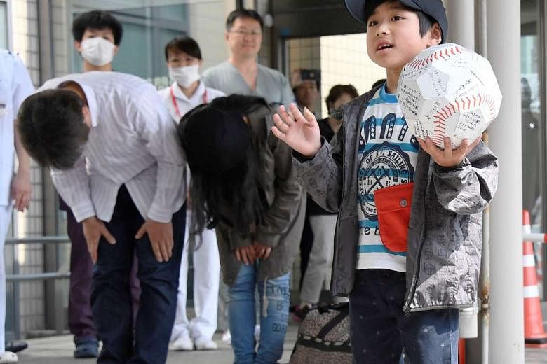 Yamato greets the crowd as he leaves Hakodate Municipal Hospital while his parents bow. Many in Japan were angry at the couple, who abandoned their son in a forest to teach him a lesson. Police said that the parents will not face charges.