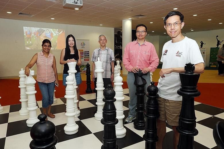 "Chess mums" (from left) Aarti Agarwal and Esther Koh, international chess master Giam Choo Kwee, SCF president Leonard Lau and "chess dad" Chan Wei Hsien at the Sports Hub Library. The efforts of chess enthusiasts and parents are drawing new young p