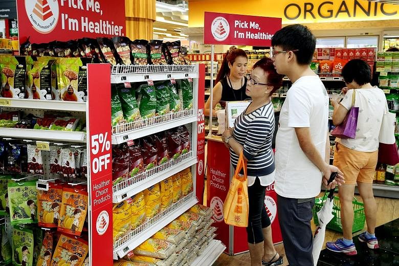 Supermarkets, including FairPrice Xtra at JEM shopping mall (above), are promoting wholegrain rice items as the Health Promotion Board says white rice is its main concern in fighting diabetes.