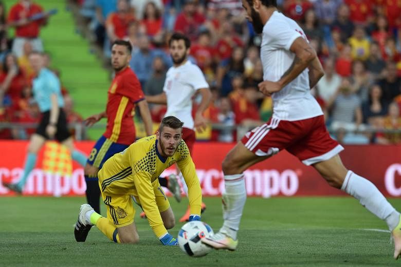 Georgia's Tornike Okriashvili finishing past Spain goalkeeper David de Gea to consign the Spanish to defeat in their last friendly before they begin their title defence. 