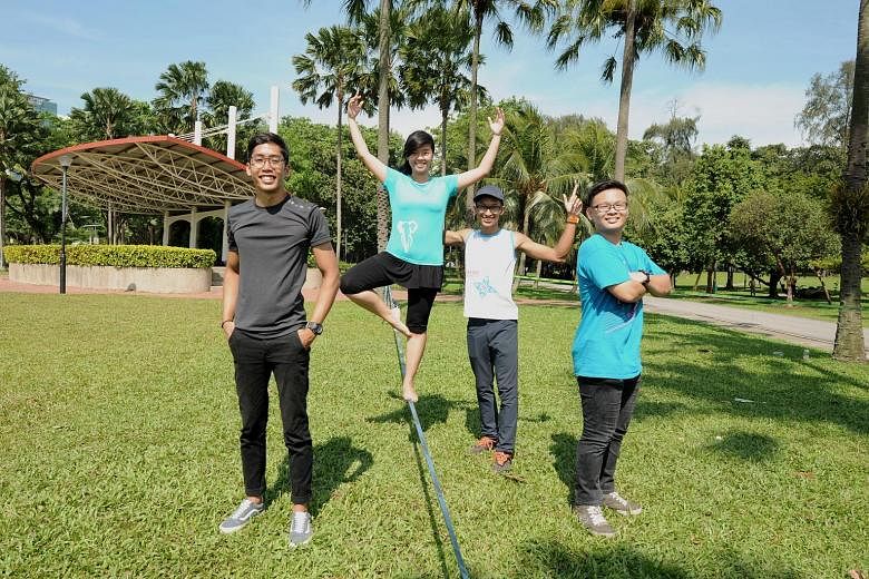 Slackliners (from left) Akid 'Ammar, Deborah Wong, Naufal Ali and Heng Yongli practising at West Coast Park.