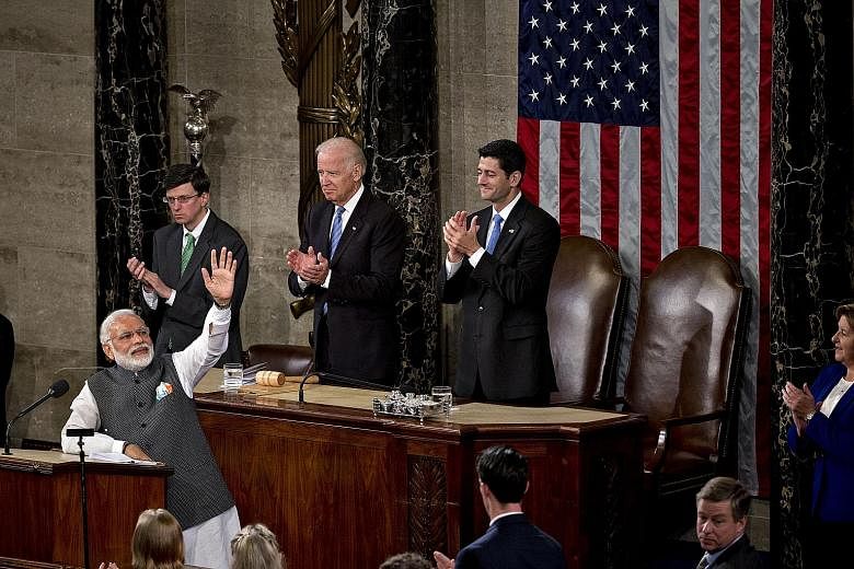 Mr Modi acknowledging the applause after making an hour-long speech to a joint session of the US Congress on Wednesday at the US Capitol in Washington. Behind the Indian Prime Minister are US Vice-President Joe Biden (centre) and Speaker of the House