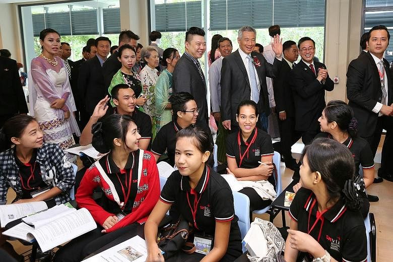 PM Lee touring the campus of the Singapore-Myanmar Vocational Training Institute with Mrs Lee and Mr Ong on the final day of his three-day visit to Myanmar yesterday. The school is modelled on Singapore's ITE.