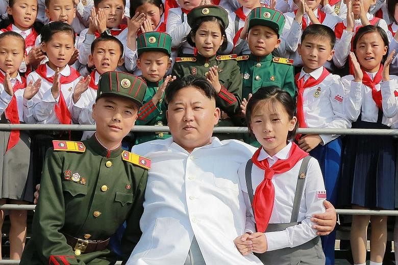 North Korean leader Kim Jong Un at a photo session with representatives of the 70th founding anniversary of the Korean Children's Union in Pyongyang. The isolated state's official Korean Central News Agency released the undated picture on Wednesday.