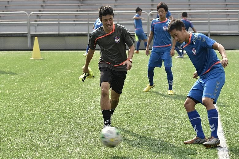 Albirex Niigata defender Ryo Kurihara (right) training with a club assistant coach (in black) at the Jurong East Stadium. The S-League leaders will hope to extend their seven-match winning streak.
