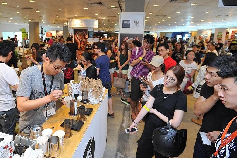 Mr Takayuki Miyazaki, 27, a barista from The Local Coffee Stand in Tokyo, Japan, showing his skills at the Good Coffee Tokyo booth on the second day of the Singapore Coffee Festival yesterday. 	The booth, featuring award-winning Japanese baristas, sh