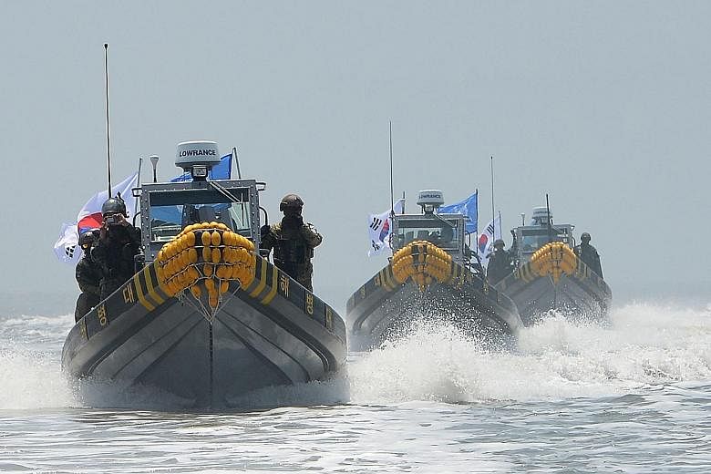 South Korean patrol boats conducting an operation to drive out illegal Chinese fishing boats from waters close to the disputed sea border with North Korea yesterday.