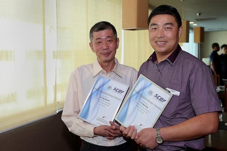 The SCDF encourages members of the public and transport operators to emulate the selfless actions of Mr Ong (far left) and Mr Jiang. The cabby and bus captain were given the Public Spiritedness Award by the Singapore Civil Defence Force yesterday.