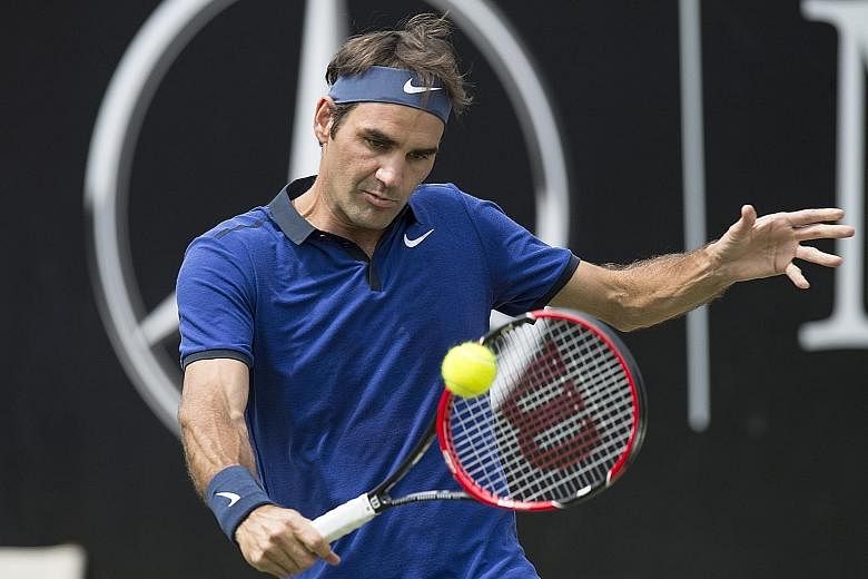 Swiss maestro Roger Federer hits a backhand return to German Florian Mayer. The world No. 3 won their Mercedes Cup quarter-final narrowly as his recovery continues to pick up steam. He had missed the French Open owing to a back injury.