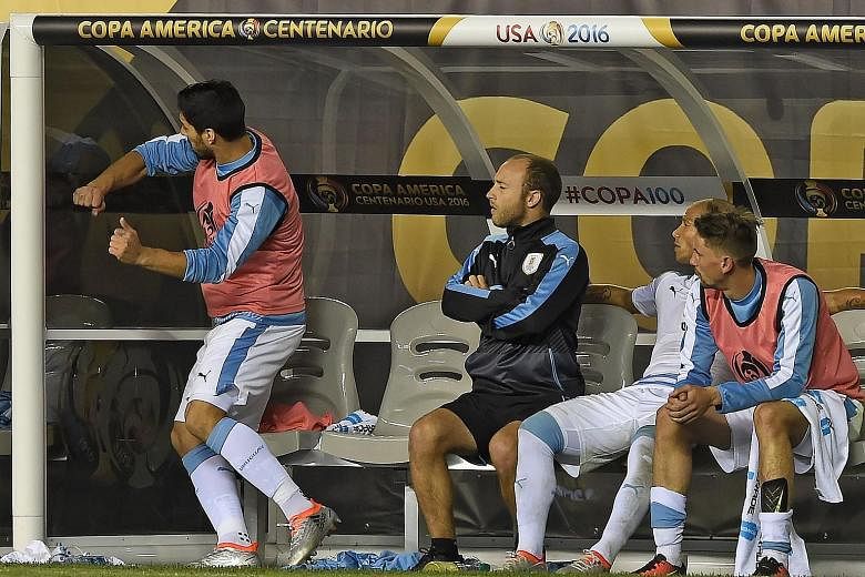 Uruguay's Luis Suarez punching the side of the dugout as he could only watch his team lose to Venezuela and be eliminated from Copa America Centenario.