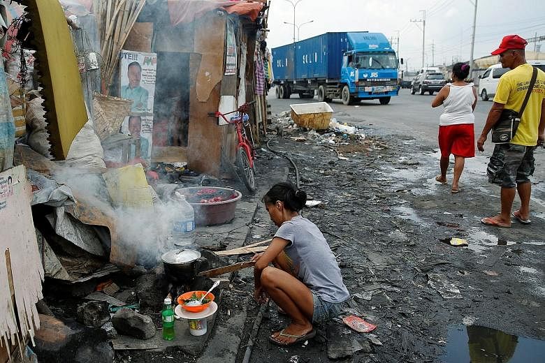 Air pollution which can arise from traffic fumes or cooking fires, such as this one in a Manila shanty town, ranks among the top 10 causes of stroke, along with better-known risks such as smoking, high blood pressure and obesity.