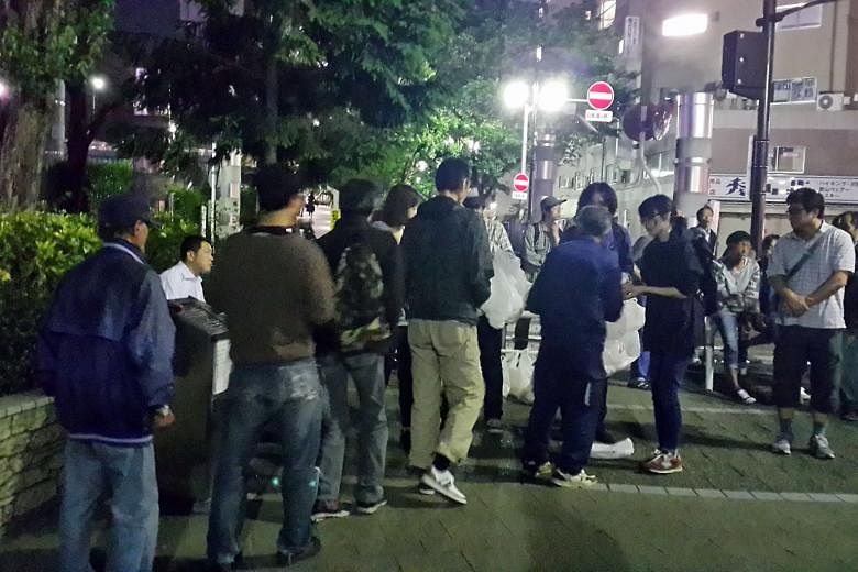 Homeless people lining up for food distributed by one of a few local non-profit organisations. Homelessness is only the tip of what analysts caution is a slow-moving tsunami of often solitary poverty as Japan's population ages. 