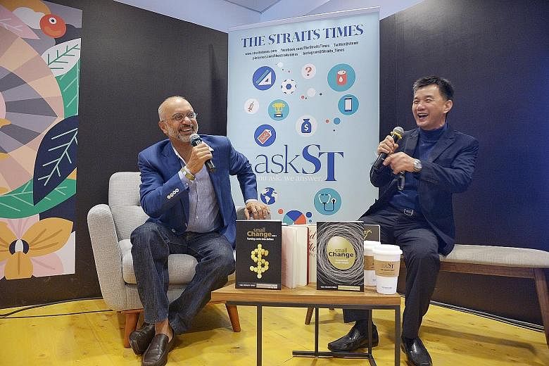 Mr Gupta (left) and Mr Goh sharing a light-hearted moment in the ST Reading Room yesterday. Over 100 people gathered to hear Mr Gupta's insights on issues such as investment and the state of the world economy.