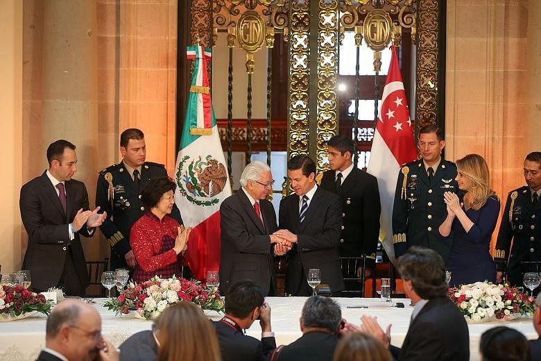 Mexican President Pena Nieto welcoming President Tan at the state luncheon at the National Palace in Mexico City. Dr Tan is accompanied by his wife, Mary (in red), while Mr Pena Nieto is accompanied by his wife Angelica Rivera (in blue).