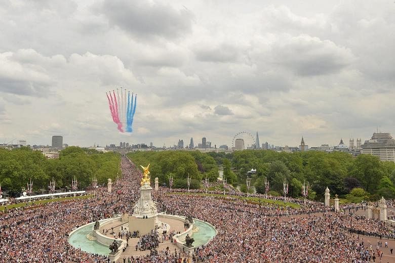A formation of Red Arrows flying over Buckingham Palace yesterday during the Trooping of the Colour, also called the Queen's Birthday Parade. More than 1,600 soldiers and 300 horses took part in the event, with a flotilla of historic boats in a proce