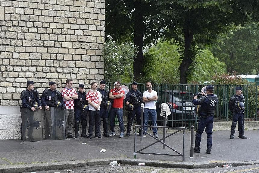 Croatia supporters seizing the day for photograph opportunities with French riot police, in a marked contrast to fan violence that marred the England-Russia game.