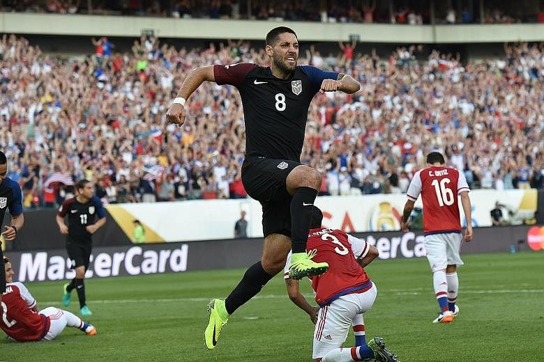 Clint Dempsey celebrates after scoring the winner for the US against Paraguay. The Americans' 1-0 win mean they enter the knockout stage as winners of their group, potentially avoiding a quarter-final showdown with tournament heavyweights Brazil.