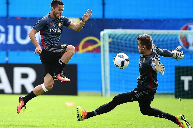 Belgium forward Eden Hazard (left) goes one on one with goalkeeper Simon Mignolet in training. While Belgium have beaten Italy just four times in 21 meetings, they beat the Azzurri 3-1 in a friendly in Brussels in November.