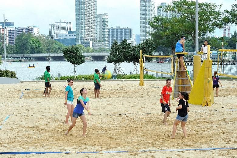 While beach volleyball (above) was one of the many attractions at the inaugural Sports Hub Community Play Day last Saturday, people of all ages tried their hand at speedminton, a modified version of traditional badminton.