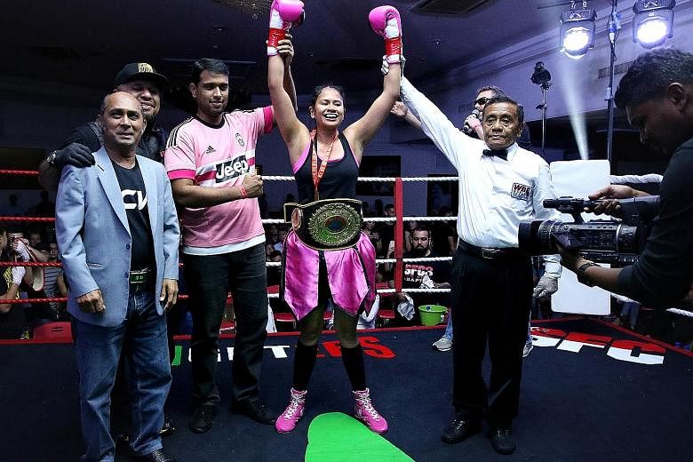 Singapore's only professional woman boxer, Nurshahidah Roslie, after winning her Universal Boxing Organisation intercontinental super featherweight title on Friday. She beat Thai Wondergirl Sithsaithong.