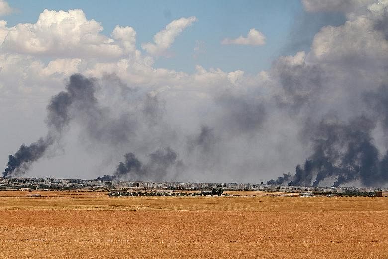 Smoke rising from Manbij in Aleppo on Wednesday. The town, which lies at the heart of the last stretch of ISIS-controlled territory along Turkey's border, was encircled by Syrian Democratic Forces troops on Friday.
