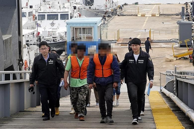 Chinese fishermen being escorted to a police station in Incheon, South Korea, on Sunday.
