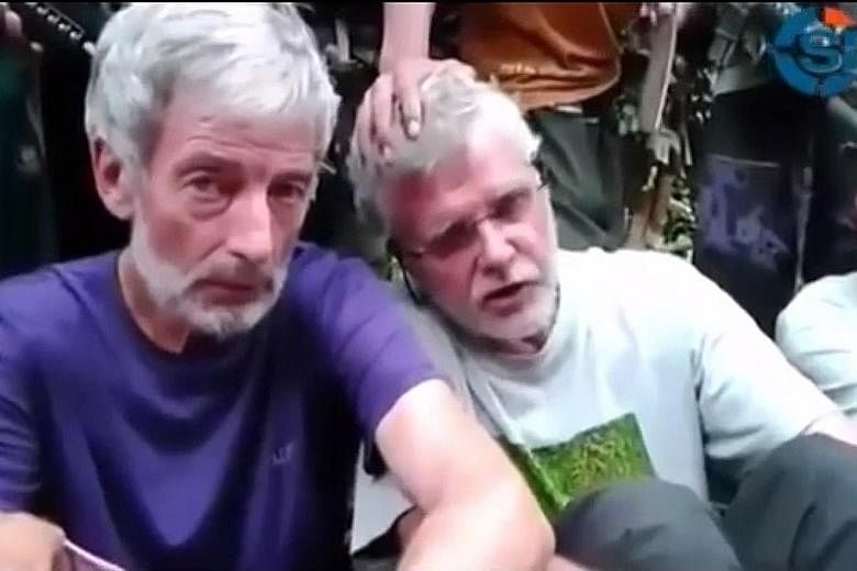 Mr Hall (left) is said to have been beheaded by the Abu Sayyaf. His compatriot, Mr Ridsdel (at right), was beheaded in April.
