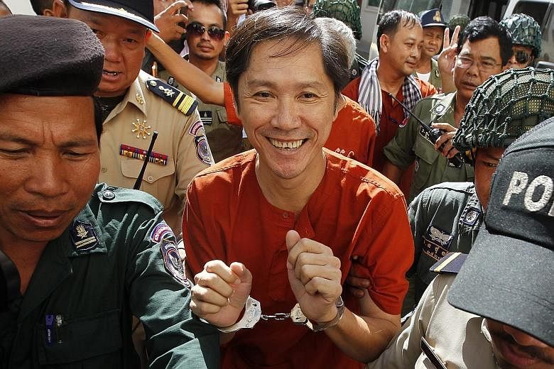 Ny Sokha, head of Monitoring of Cambodian Human Rights and Development Association, being escorted to the appeals court in Phnom Penh yesterday. He is among the dozens of critics and activists that have been arrested by the Hun Sen government in rece