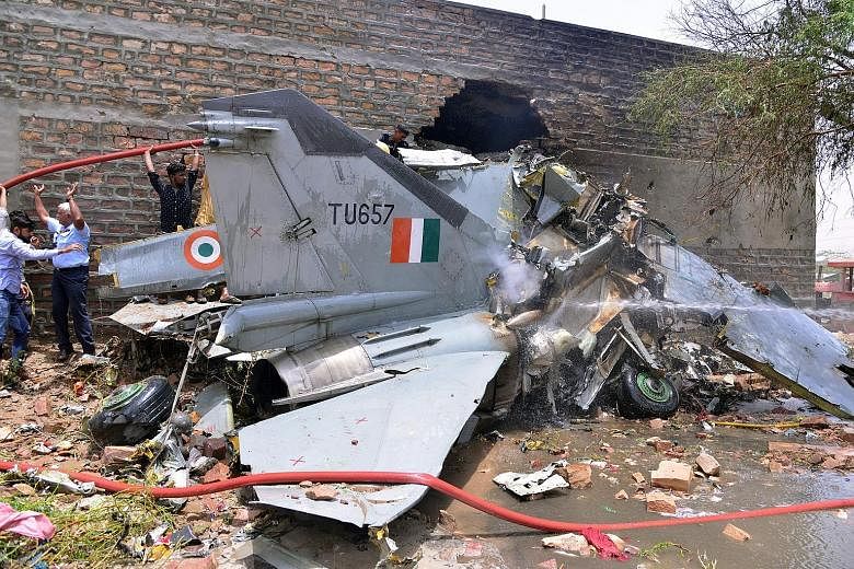 An Indian Air Force MiG-27 fighter jet crashed near the western state of Rajasthan's Jodhpur city yesterday, a senior defence official said. Though two pilots ejected safely, three people on the ground were injured and a building near the crash site 