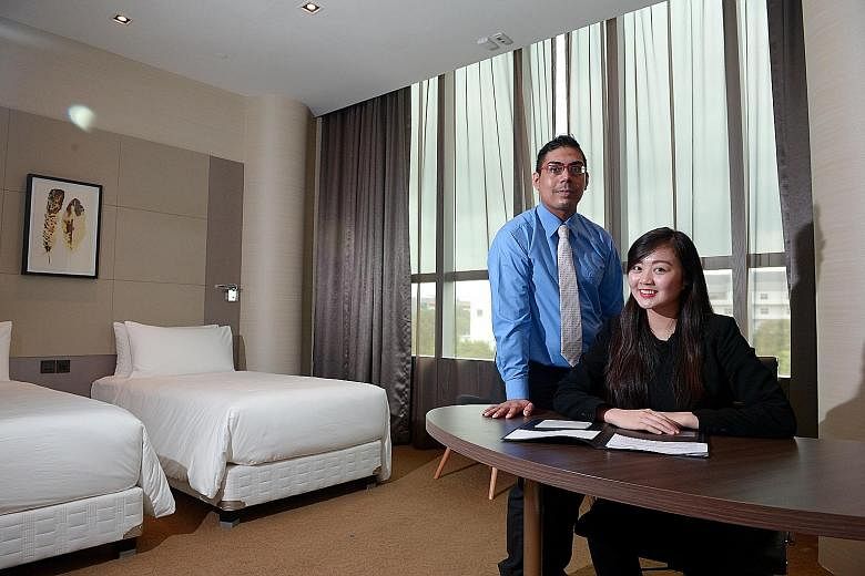Mr Mohamed Aslam Mohd Rafeek, 26, and Ms Charlene Chong, 20, at Republic Polytechnic's "hotel lab" training facility. They are participants in a SkillsFuture Earn and Learn Programme for the hotel sector. The course opens to ITE graduates from Octobe