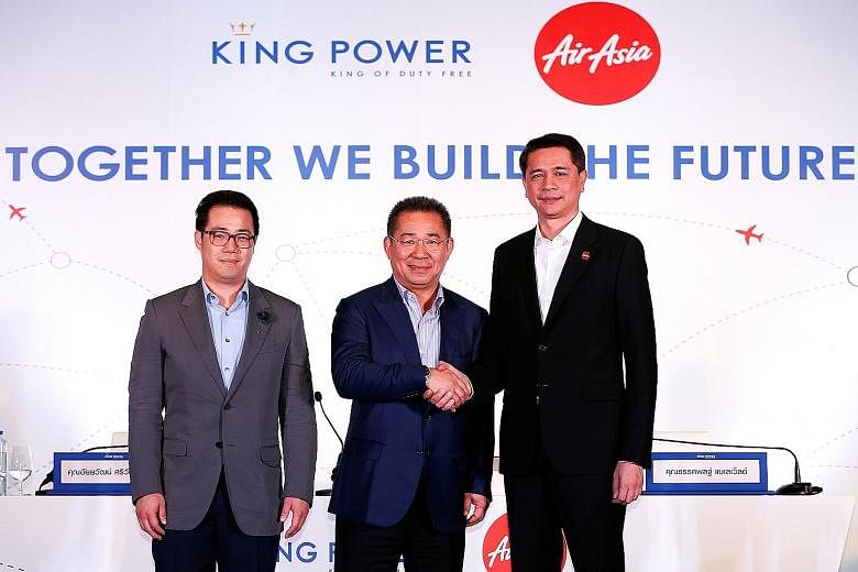 Mr Vichai, King Power's chairman (centre), with Mr Bijleveld, Thai Air Asia's CEO (right), and Mr Aiyawatt, King Power's CEO, at the signing of the deal yesterday.