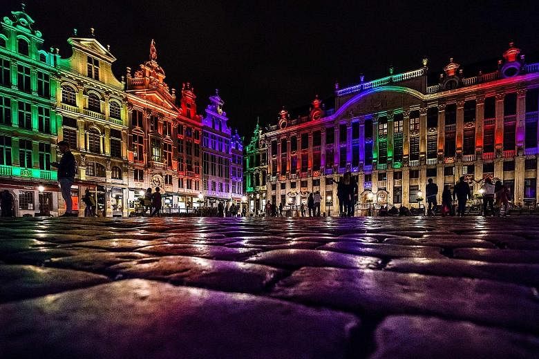 The heritage buildings of the Brussels Grand Place lit up in the colours of the LGBT rainbow flag on Monday to honour the victims of the mass shooting at a gay nightclub in Orlando, Florida, on Sunday.