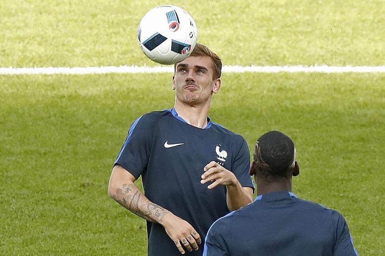 France's Antoine Griezmann (facing camera) and Paul Pogba during training. Griezmann's effectiveness may have been blunted by his duties with Atletico Madrid, while France coach Didier Deschamps said he expected "much more" of Pogba.