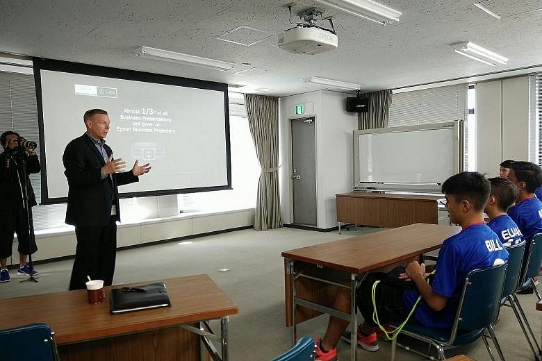 Ian Cameron, general manager of Epson (global brand and communications), speaking to several Singapore youth players who are training in Japan with Matsumoto Yamaga under the company's global sponsorship.
