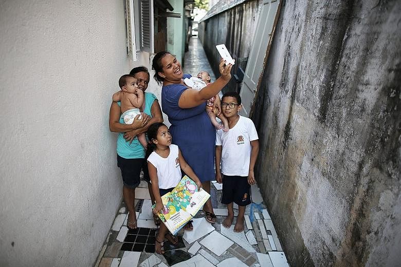 Brazilian mother Jaqueline Jessica Silva de Oliveira taking a selfie with her family in April. She recently gave birth to twins, and one of them has microcephaly, a birth defect associated with Zika.