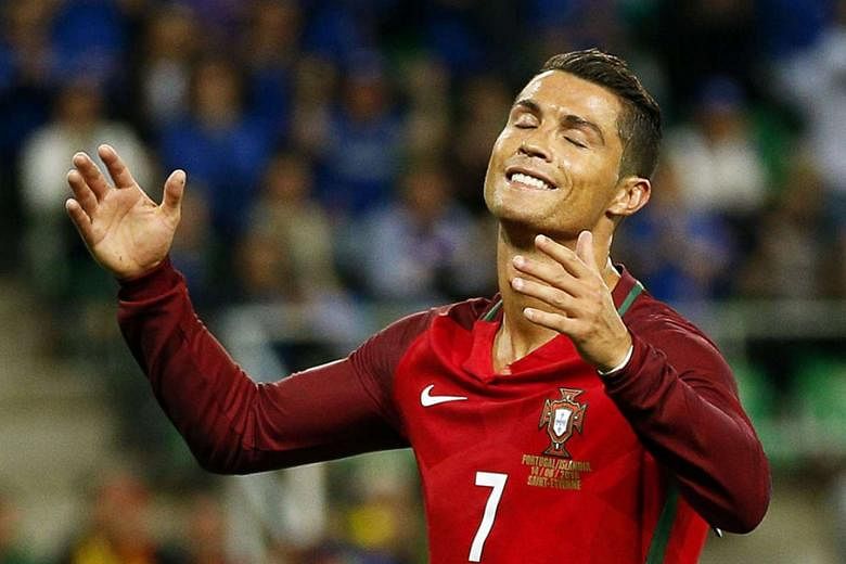 Portuguese captain Cristiano Ronaldo ruing one of his five missed attempts at the Stade Geoffroy Guichard in St Etienne. While he showed his disdain for his opponents' stupendous achievement on their tournament debut, his own side was to blame for a frust