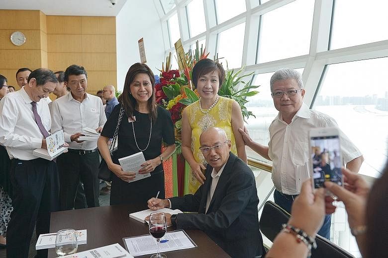 Guests with Mr Han (seated) at his book launch yesterday, including Mr Liak Teng Lit (at left), group CEO of Alexandra Health System.