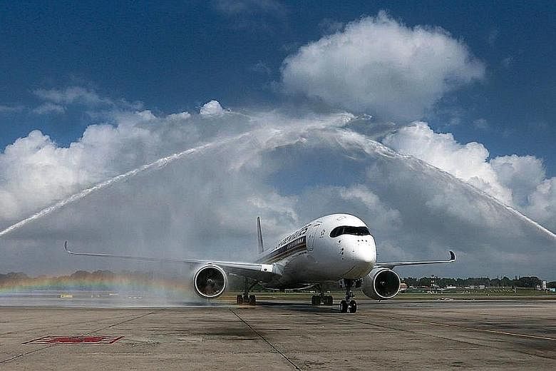 Two fire engines giving the first of 67 Airbus 350s a water-cannon salute on its arrival at Changi Airport's Terminal 3 on March 3. The new SIA flights to San Francisco will use A350-900 aircraft.