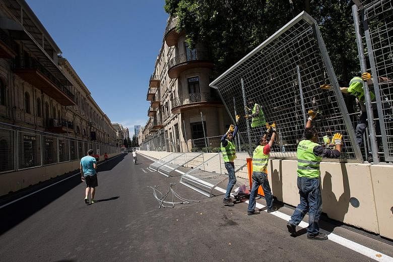 Workers fixing fences at the Baku street circuit in the Azerbaijan capital. The European Grand Prix returns after a three-year break as the former Soviet republic makes its debut on the F1 calendar.