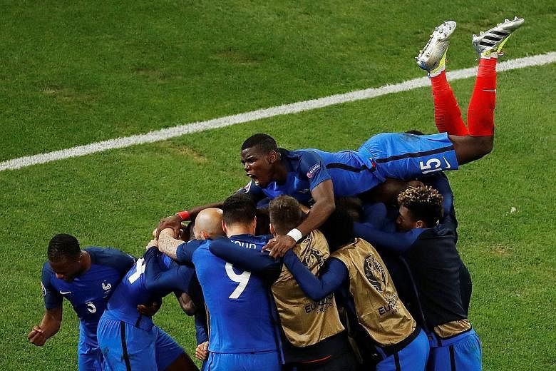 The French team celebrating substitute Antoine Griezmann's 90th-minute goal, which finally broke Albania's resistance. France regulars Paul Pogba and Antoine Griezmann both started on the bench against Albania.