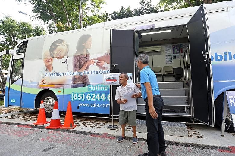 Ang Mo Kio Block 203 resident Ng Kim Beng, 67, was one of those who underwent the tuberculosis screening yesterday, which included a blood test at the block's void deck (left) and an X-ray in a medical services bus (below). Results from the tests and